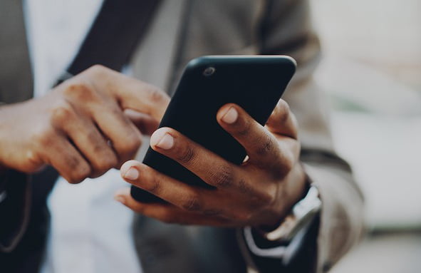 Woman checking phone, representing data exposure.